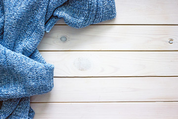 Fototapeta na wymiar Sweater woolen blue on light wooden background, flat lay, copy space