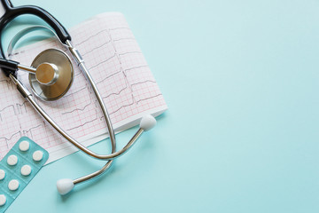 Cardiogram and stethoscope on blue