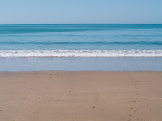 Fototapeta na wymiar Shore of the beach with clear water