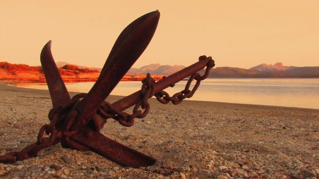 A view of the beach with some rusty elements in the foreground as main object