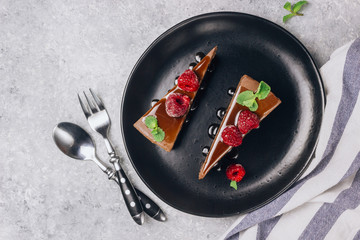 chocolate or coffee cheesecake with glaze, mint and raspberry