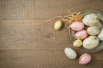 Easter holiday background with golden glitter easter eggs decorations on wooden table.