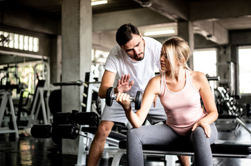Portrait Fitness coaches are controlling the training equipment of lovers, Helps create motivation for exercise,fitness concept 