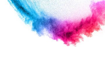 Multi colour powder explosion on white background. Launched colourful dust particles splashing.