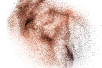 Abstract deep brown dust explosion on white background.  Freeze motion of coffee liked color dust splash.
