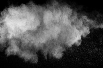 White powder explosion isolated on black background. White dust particles splash.Color Holi Festival.
