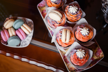 Still life of served coffee cups, macaroon cookies, marshmallows and apples