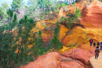 Editorial illustrative. Roussillon Provence France. February 9, 2019. Tourists on the hiking trail in the ocher canyon. Winter tourism.
