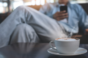 Man using mobile phone and coffee