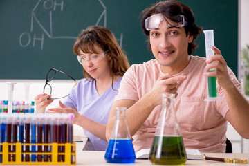 Two chemists students in classroom 