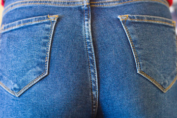 Fototapeta premium Female ass in jeans closeup
