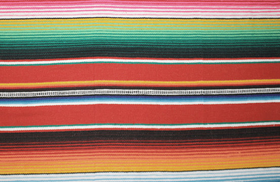 mexican blanket poncho Mexican cinco de mayo rug blanket serape fiesta traditional Mexico poncho background stripes copy space minimal simple cinco de mayo serape pattern background  -  stock photo
