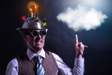 distraught looking conspiracy believer in suit with aluminum foil head with chemtrails cloud...