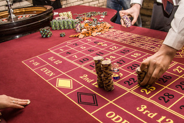 roulette accessories on red gaming table