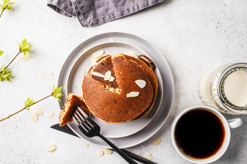 Pancakes stuffed chocolate on gray plate with coffee for breakfast, top view.