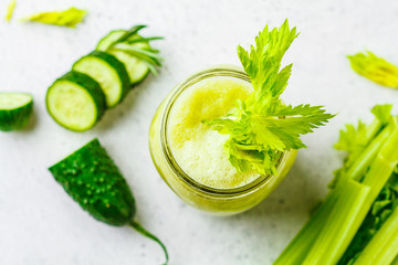 Green detox celery cucumber juice in a glass jar.