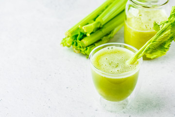Green detox celery juice in a glass, copy space.