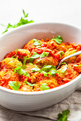 Baked vegan bean meatballs in tomato sauce.