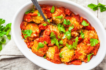Baked vegan bean meatballs in tomato sauce.
