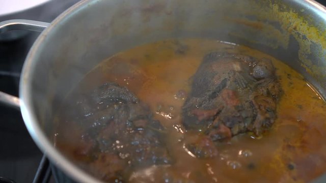 Stewing beef and vegetables. Traditional meat stew with tomato and vegetables.