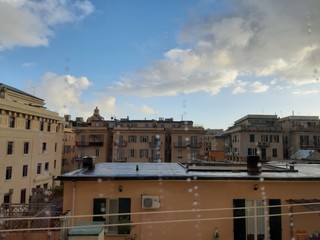 Fototapeta na wymiar Genova, Italy - 03/05/2019: An amazing caption of the waterdro on the window with beautiful background of a blue sky and some white clouds.