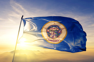 Minnesota state of United States flag waving on the top sunrise mist fog