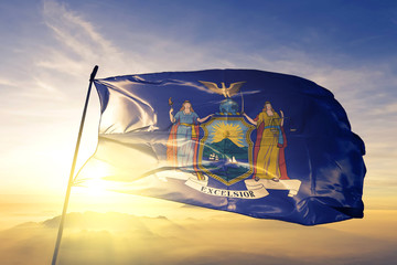 New York state of United States flag waving on the top sunrise mist fog