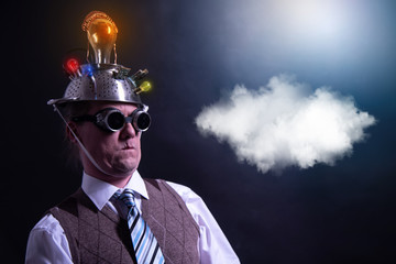 distraught looking conspiracy believer in suit with aluminum foil head with chemtrails cloud...