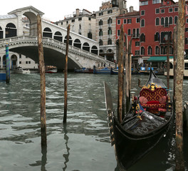 gondola moored on the Grand Canal near the Rialto Bridge in Veni