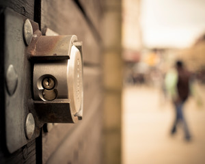 Detail of a lock whith blurred person in the background