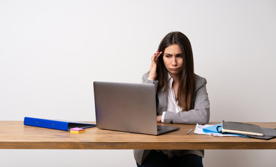 Business woman in a office having doubts and thinking