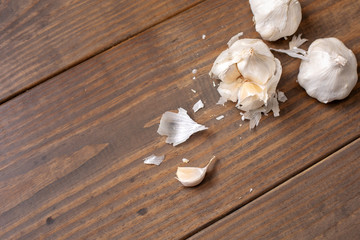 Garlic Bulb and Cloves on a Wooden Table; One Isolated in Front
