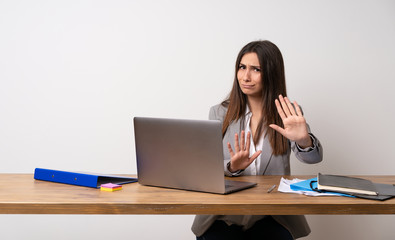 Business woman in a office nervous and scared stretching hands to the front