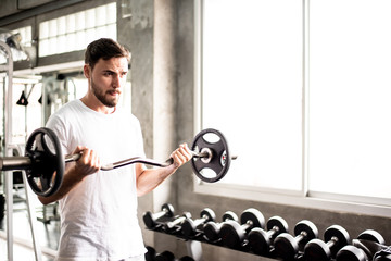 Portrait Caucasian handsome young man Are building muscles with exercise machines,healthy sports lifestyle, Fitness concept