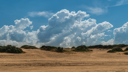 dune landscape with blue sky and clouds on a sunny day
