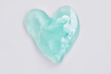 Green slime for kids in a heart shape, transparent funny toy. Isolated on Withe Background 
