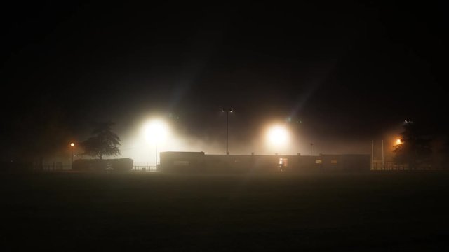 football club building at night with fog lit by lamps