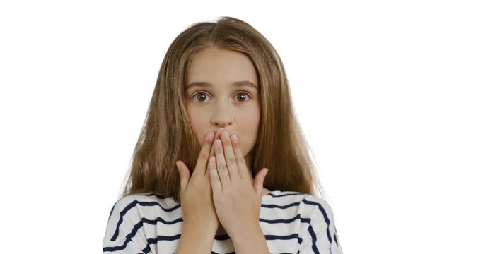 Close up of the blonde teenager girl with long hair in the striped blouse closing her mouth with hands and doing oops grimacing face. White background.