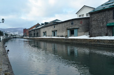 Fototapeta na wymiar ancient warehouse on Otaru canal old port town and landmark in Hokkaido Japan