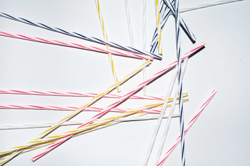Array of colorful thin candle sticks on a white background