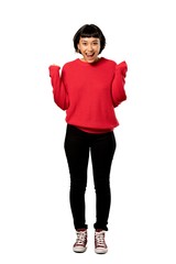 A full-length shot of a Short hair girl with red sweater celebrating a victory in winner position...