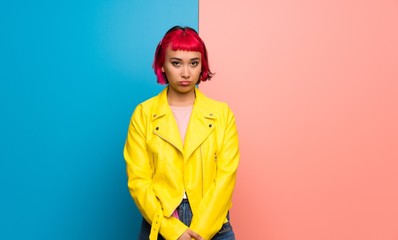Young woman with yellow jacket with sad and depressed expression