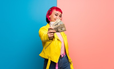 Young woman with yellow jacket taking a lot of money