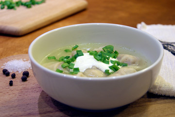 Bowl of handmade dumplings with sour cream