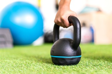 Young sport woman in a gym with kettlebell
