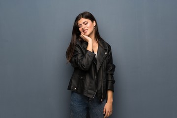 Teenager girl over grey wall with toothache