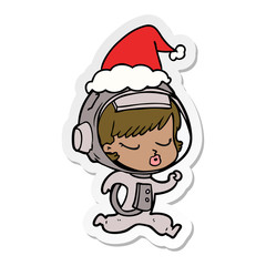 sticker cartoon of a pretty astronaut girl running wearing santa hat