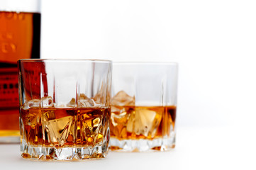Glasses of scottish whiskey with ice cubes