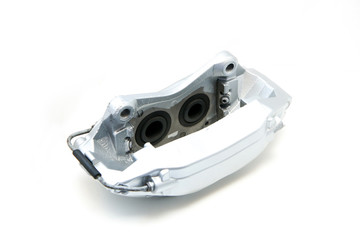 Silver four piston sports brake calliper isolated on a white background. 