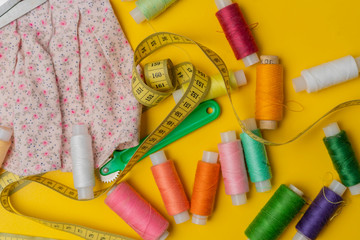 sewing supplies on yellow background
